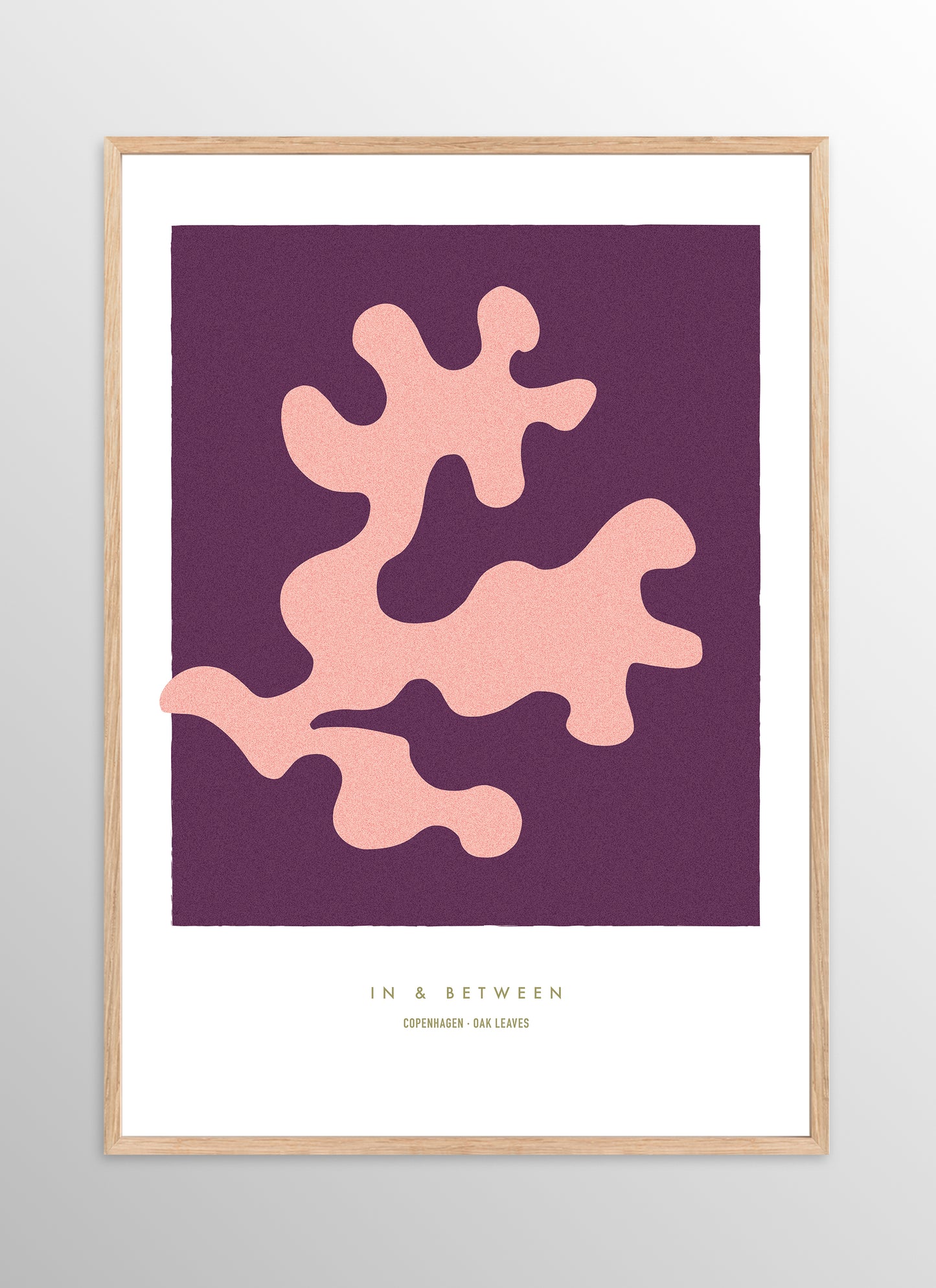 Art print of peach oak leaf on dark violet background in natural wooden frame.