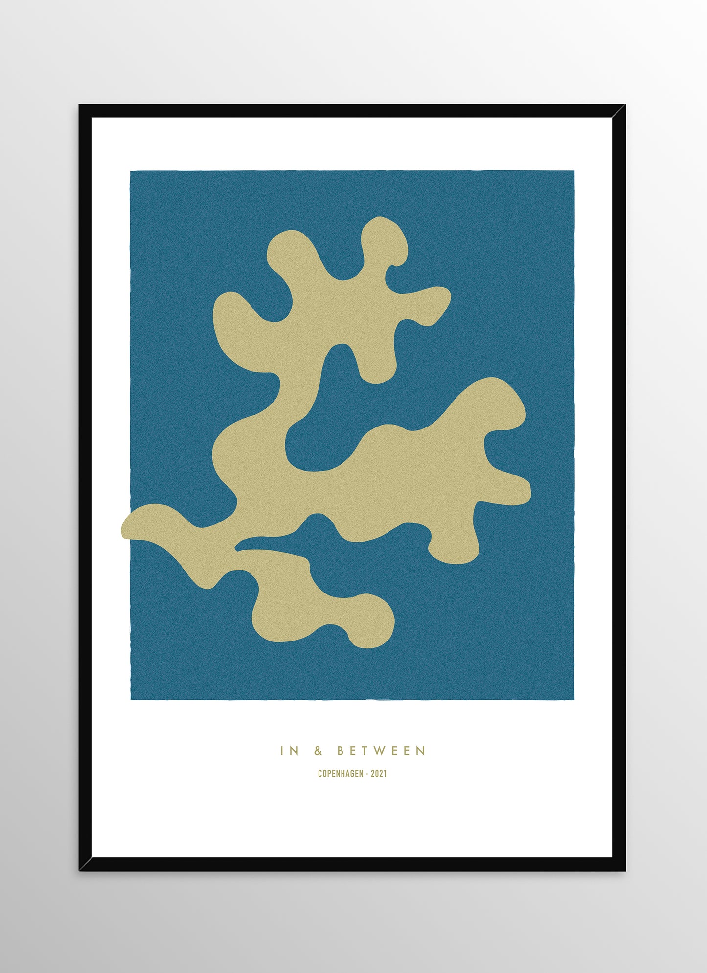 Art print of golden oak leaf on dark blue background in black wooden frame.
