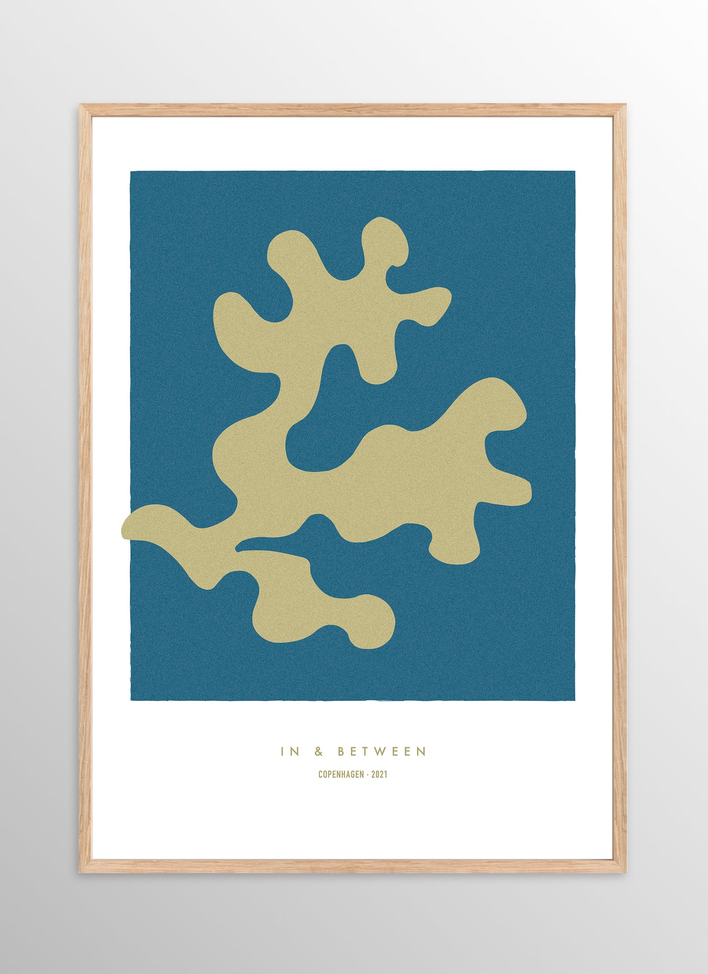 Art print of golden oak leaf on dark blue background in natural wooden frame.