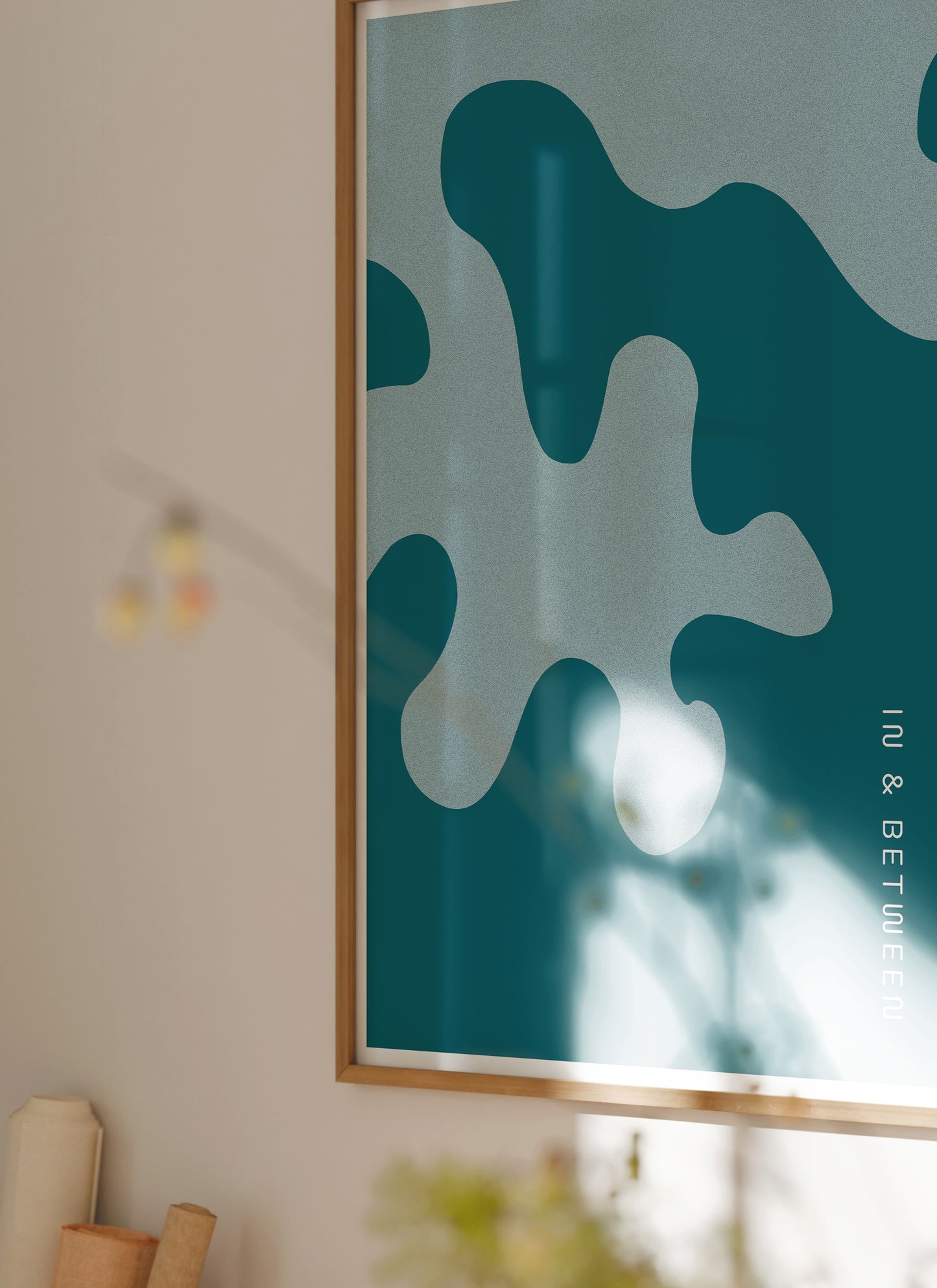 Lifestyle image of In and Between art print of large deep blue and light blue oak leaf and background in natural wooden frame.