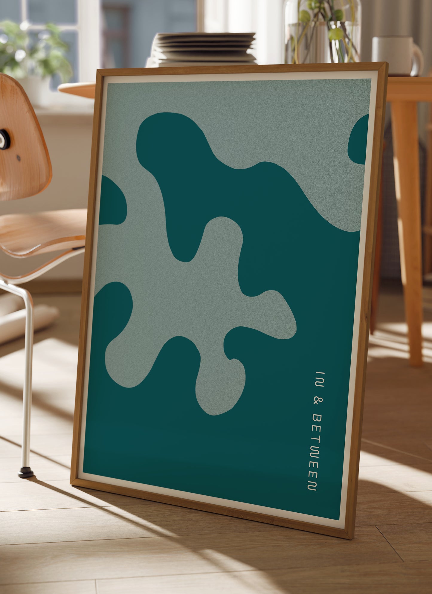 Lifestyle image of In and Between art print of large deep blue and light blue oak leaf and background in natural wooden frame.