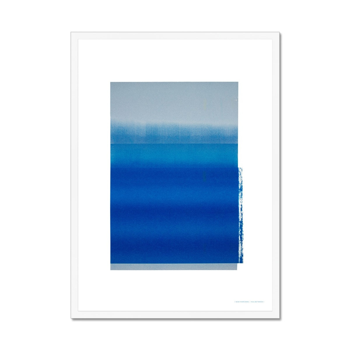 White wood framed giclee print depicting a vibrant blue horizon within a wide white border. From being completely saturated at the bottom the pigments of colour slowly spread out upwards until it fades into space at the top like the horizon.