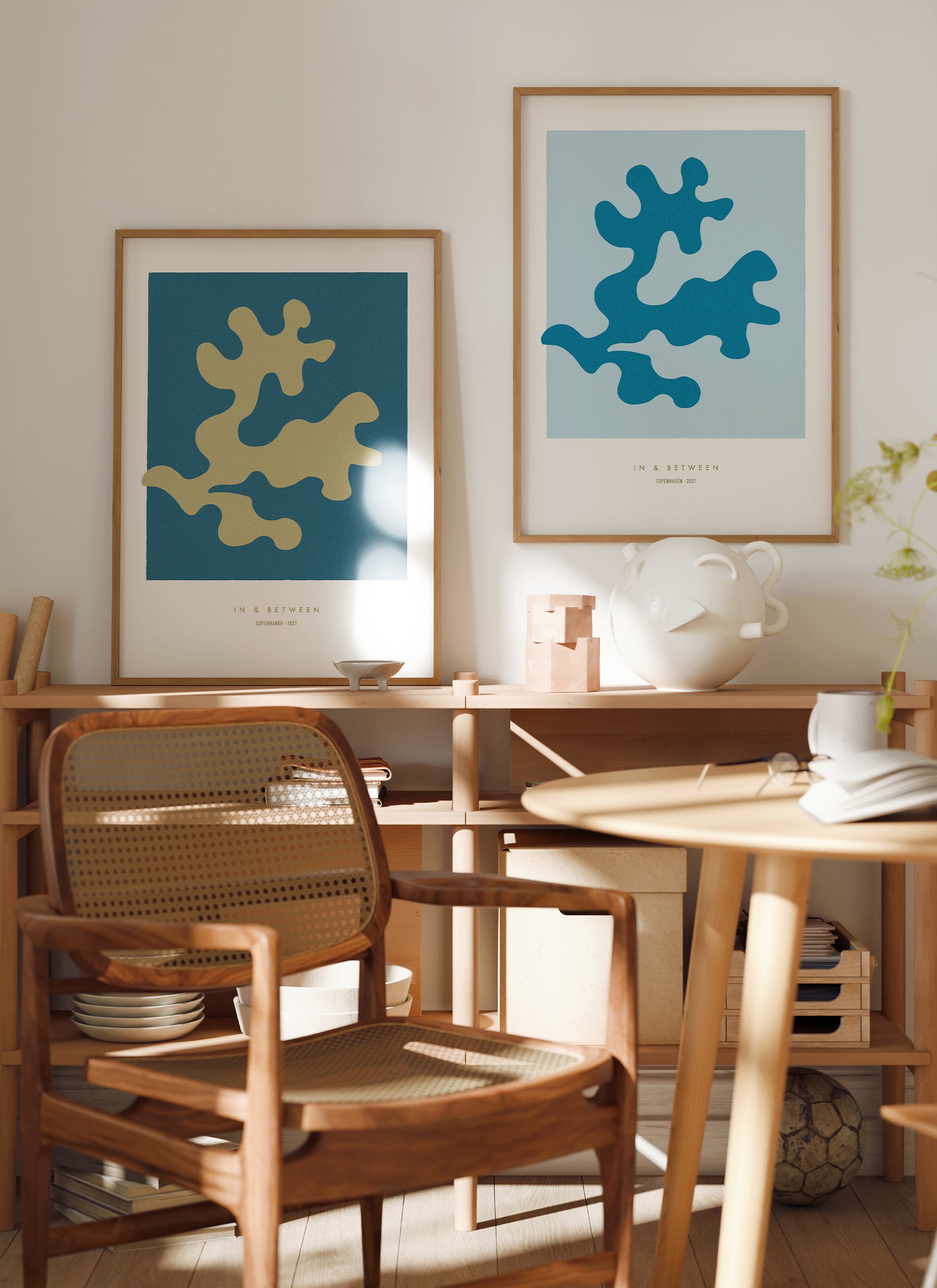 Lifestyle image with art print oak leaf and background in light blue in natural wooden frame.