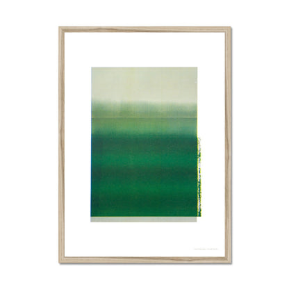 Natural wood framed giclee print depicting deep green horizon within wide white border. From being completely saturated at the bottom the pigments of colour slowly spread out upwards until it fades into space at the top like the horizon.