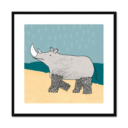 Art print of rhino with patterned legs in pale yellow and teal landscape and pale blue sky with large raindrops in a black wooden frame.