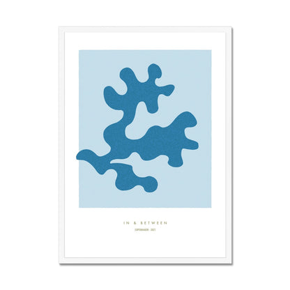 Art print of soft blue oak leaf on light blue background with white space around in white wooden frame.