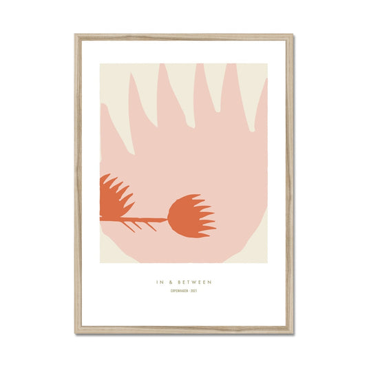 Art print of one large thistle flower light red with a smaller thistle flower in left side on a cream background with white space around and a natural wooden frame.