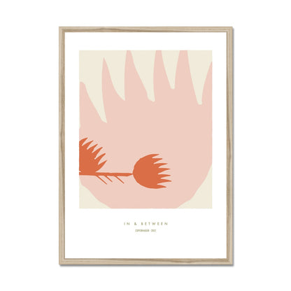 Art print of one large thistle flower light red with a smaller thistle flower in left side on a cream background with white space around and a natural wooden frame.