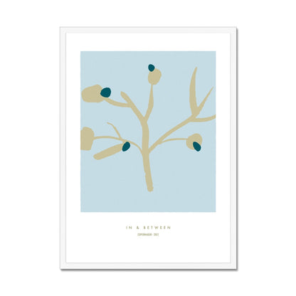 Upright golden olive tree branch with dark green olives on a light blue background in a white wooden frame.